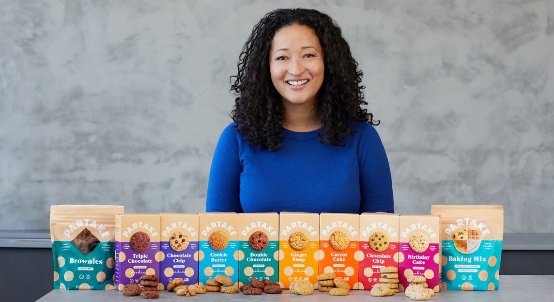 a woman holding a box of cookies