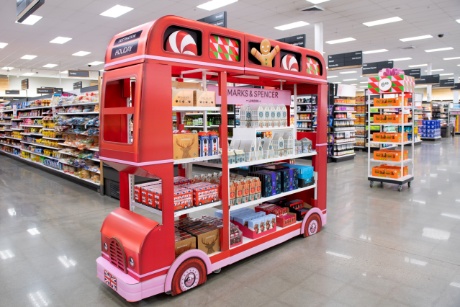 A red double-decker bus display filled with Marks & Spencer treats.