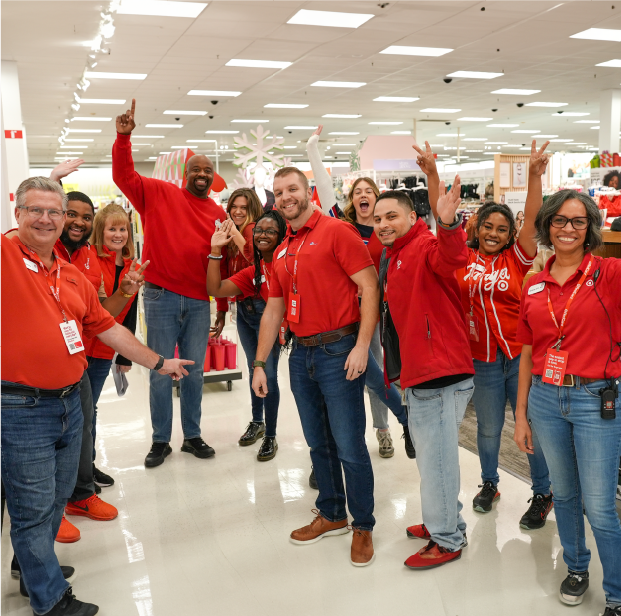 The store team from Target’s Smyrna store stand together, smiling and flashing peace signs.