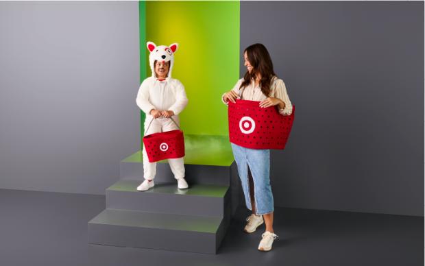 A child in a Bullseye Dog costume holding a felt Target basket next to an adult wearing a Target basket costume.