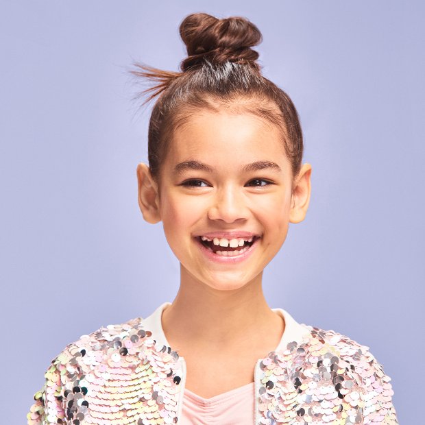 a smiling girl with a ponytail