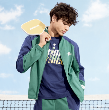 A model wearing a green and blue Prince for Target track suit.