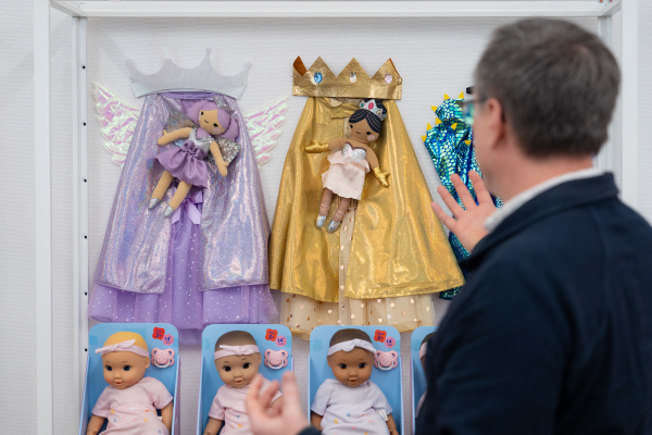 Jeff Carter looks at an array of Gigglescape dress-up items and matching dolls