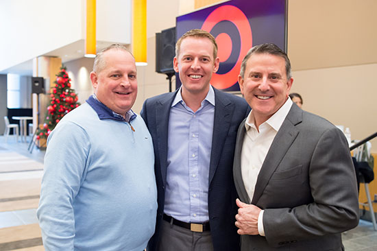 Bill Smith stands with John Mulligan and Brian Cornell in Target Hall
