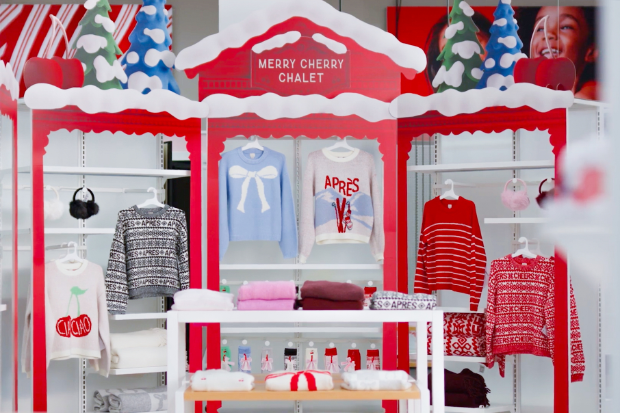 Target’s Merry Cherry Chalet display is full of holiday sweaters and accessories.