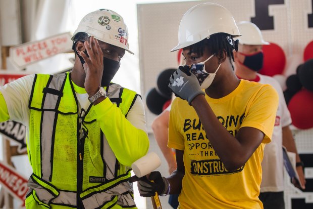 a couple of men wearing helmets