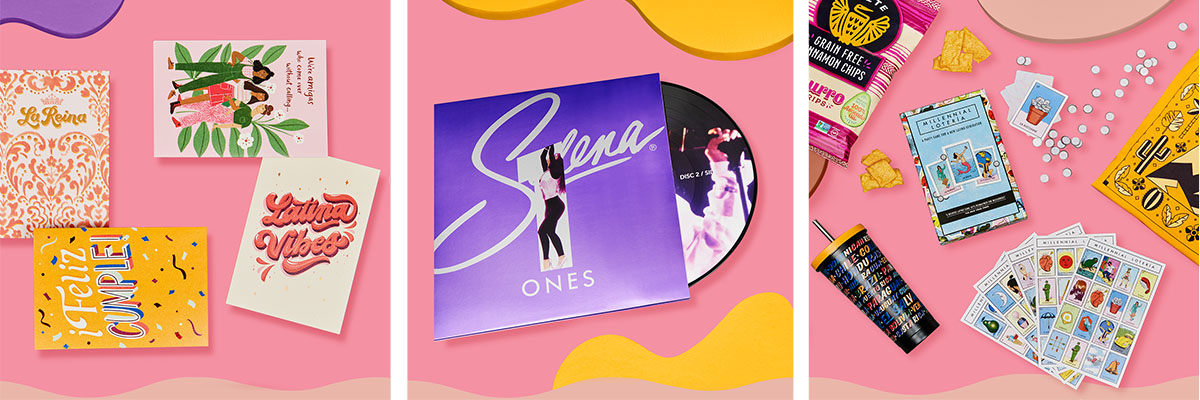 Three pink boxes display four notebooks, a vinyl album cover for Latina musician Selena, and a board game spread out with snacks.