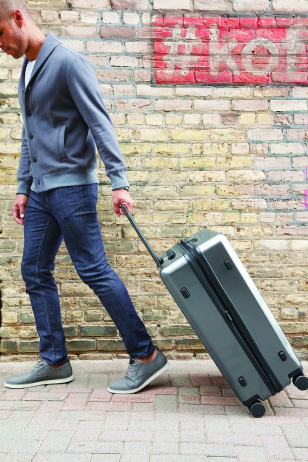 a person pushing a suitcase