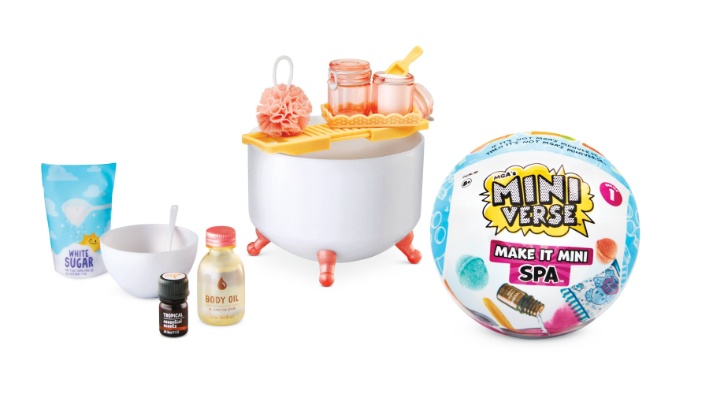 A white background displays a colorful miniverse inflatable ball and toy spa items such as body oil, essential oils and bath scrubs.