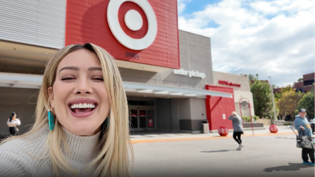 Actress Hilary Duff smiling outside a Target store.