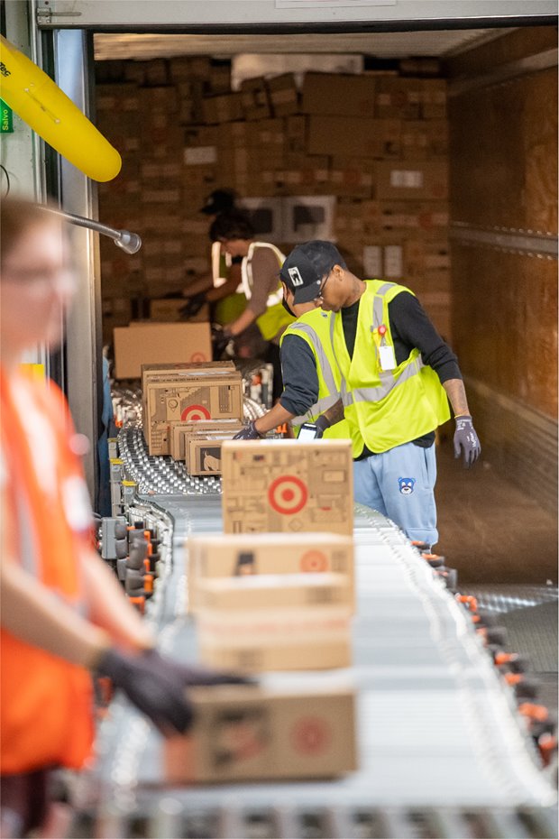 a man in a safety vest working in a warehouse