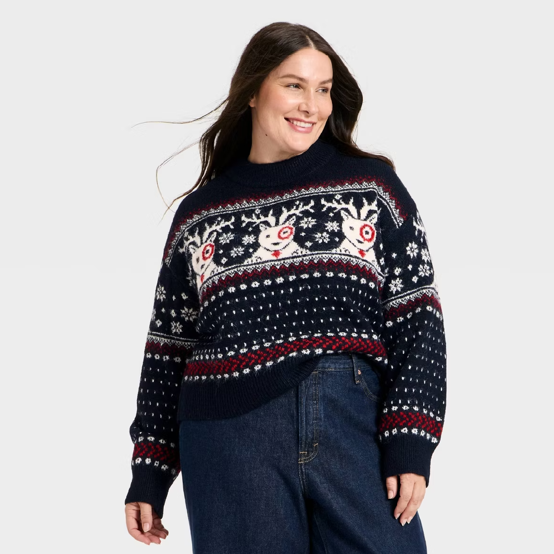 A model wearing a holiday sweater with Bullseye dog patterns