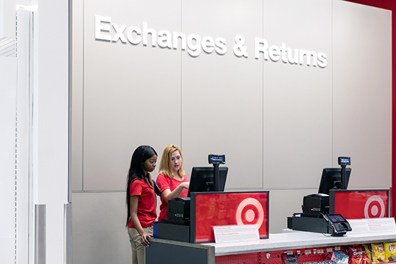 Two team members at the Exchange counter