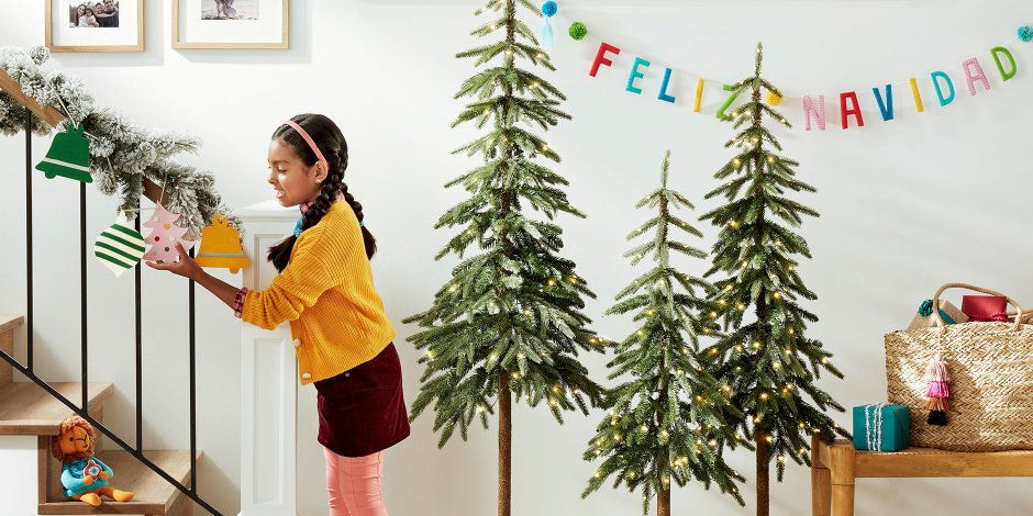 a girl standing next to a tree