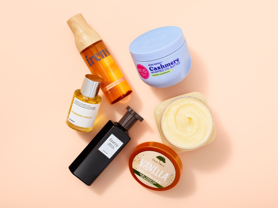 A variety of beauty products on a peach-colored background.