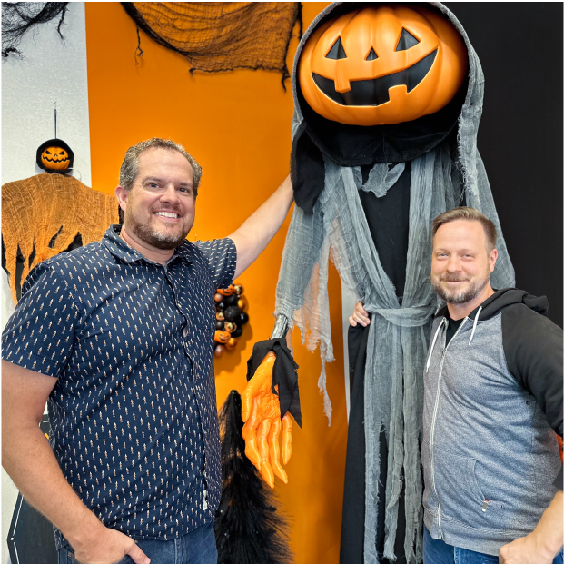 Target senior product designers Chris S. and Adam H. pose with Lewis The Pumpkin Ghoul and other Halloween decor.