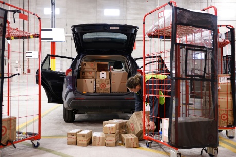 A driver fills the back of their vehicle with boxes of guest orders.