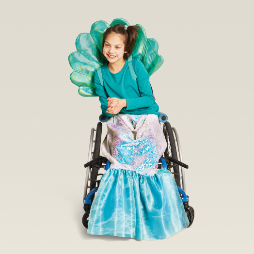 a child in a wheelchair wearing an adaptive mermaid costume