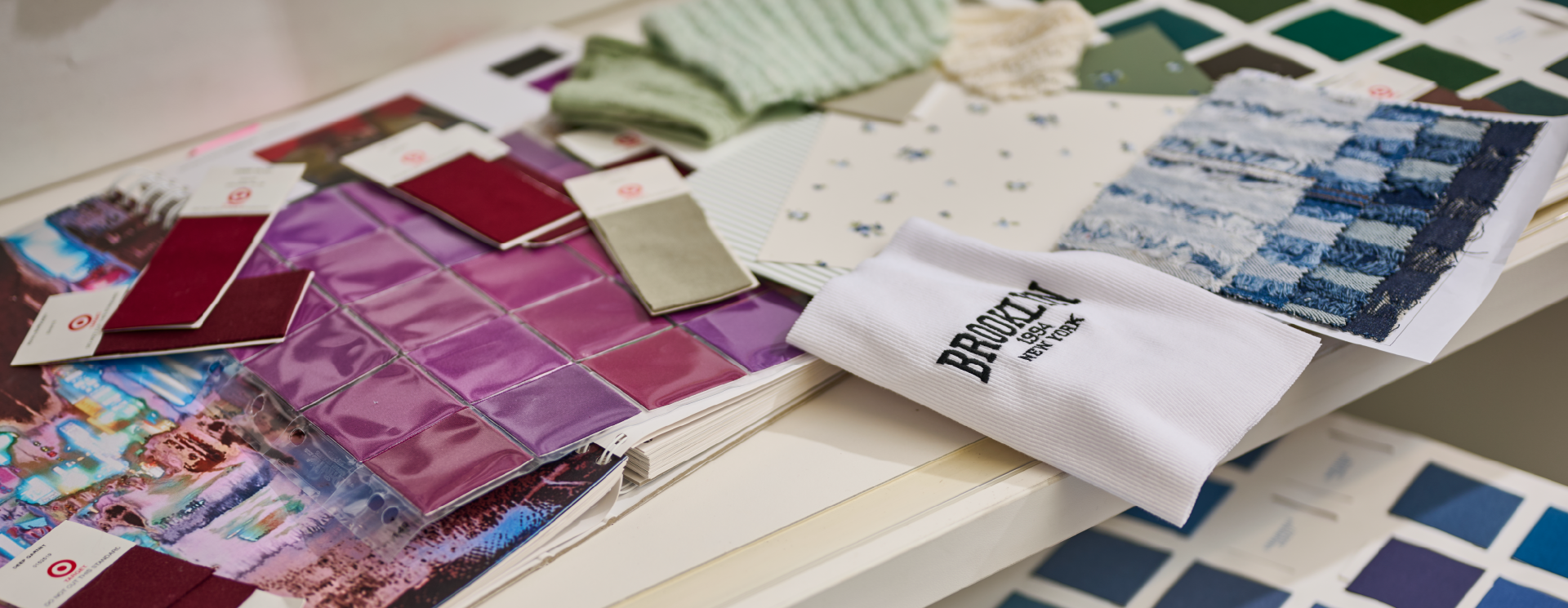 A counter is spread with colorful fabric swatches.