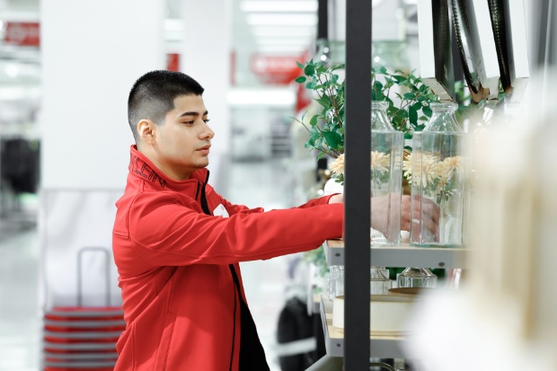 A team member arranges a display of artificial flowers.