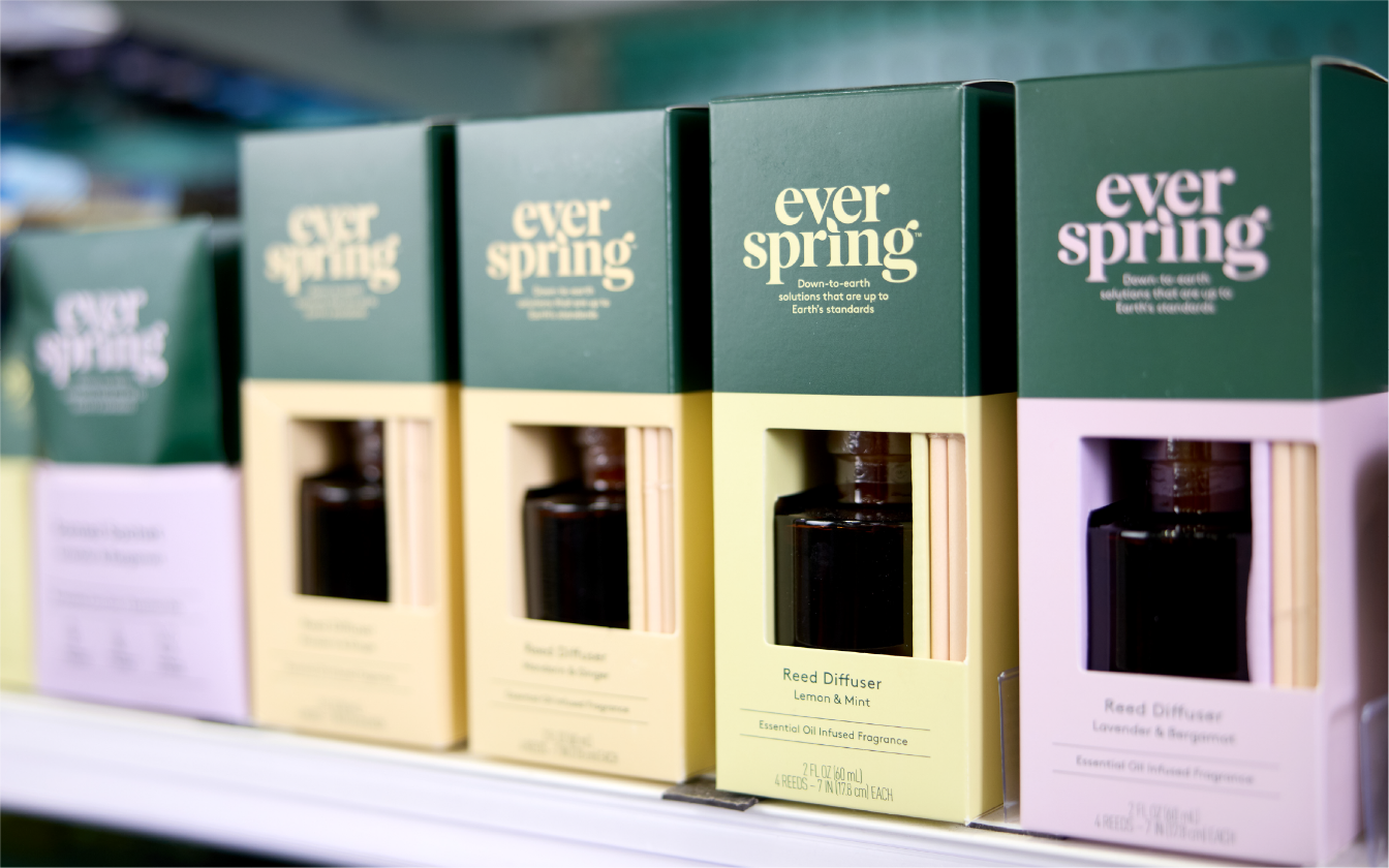 A row of Everspring scent diffusers line a store shelf.