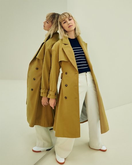 a couple of women in trench coats
