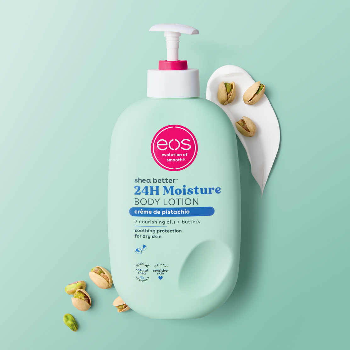 A bottle of EOS body lotion in creme de pistachio scent, with pistachio nuts laying near the bottle.