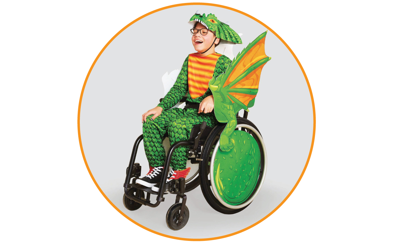 Jonas models a green and yellow dragon costume, with the wheels of his wheelchair decorated as wings.