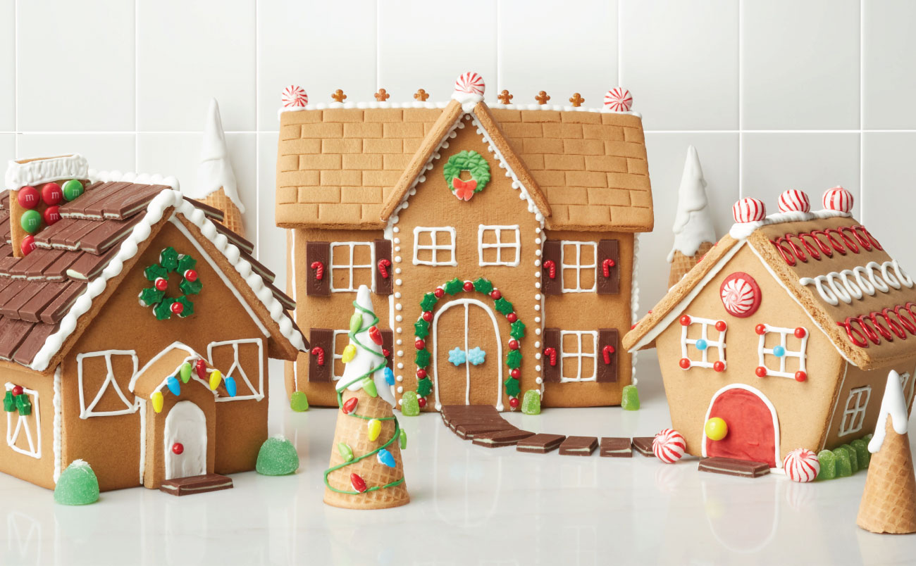 Three elaborately-decorated gingerbread houses