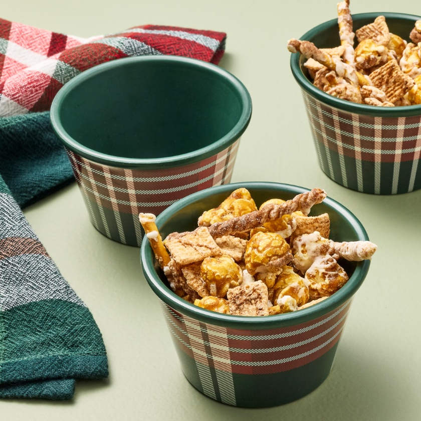 green plaid bowls filled with holiday snack mix