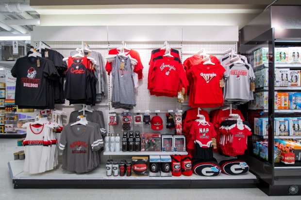 a shelf with different jerseys and shirts