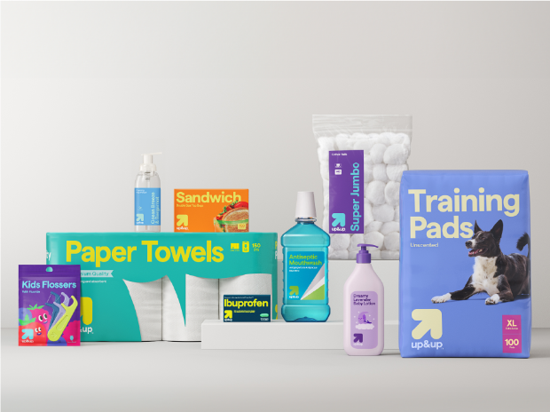 An array of up&up products including paper towels, sandwich bags, mouthwash, lotion, kids' flossers, cotton balls and dog training pads.