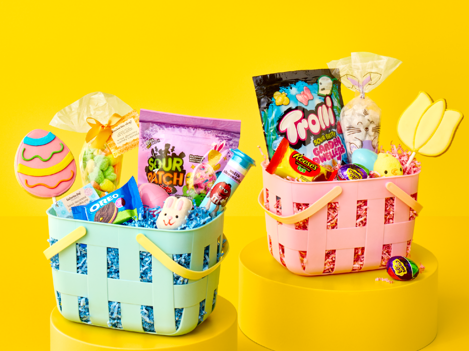 Two colorful Easter baskets filled with assorted candy, including gummies and chocolate treats, set against a bright yellow background