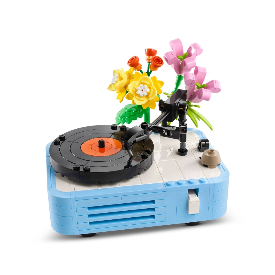 A colorful LEGO model of a retro-style record player with a vinyl disc and decorative flowers attached.