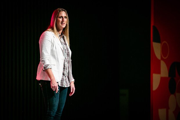 a woman standing in front of a wall