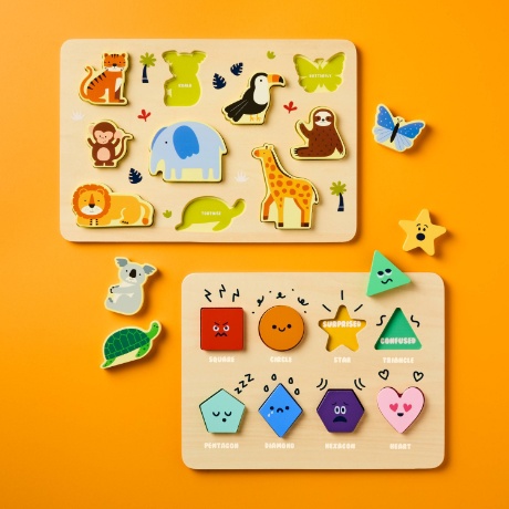 A wooden puzzle board displays scrambled shapes and animals in gameplay.