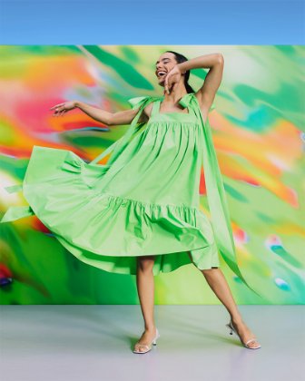 a woman dancing in a green dress