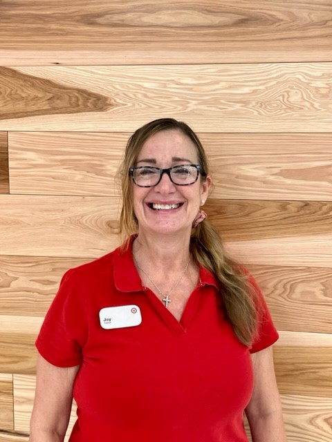 Photo of team member in a store against wood background