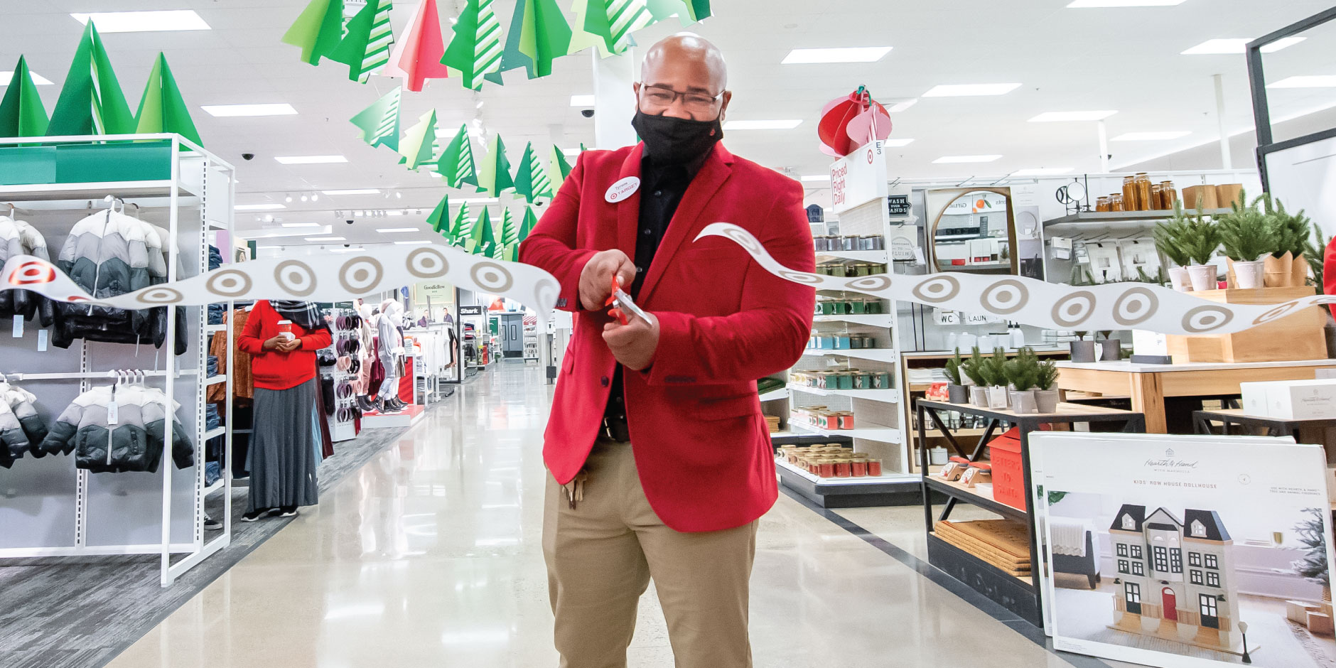 a person wearing a red coat and holding a white object in a store