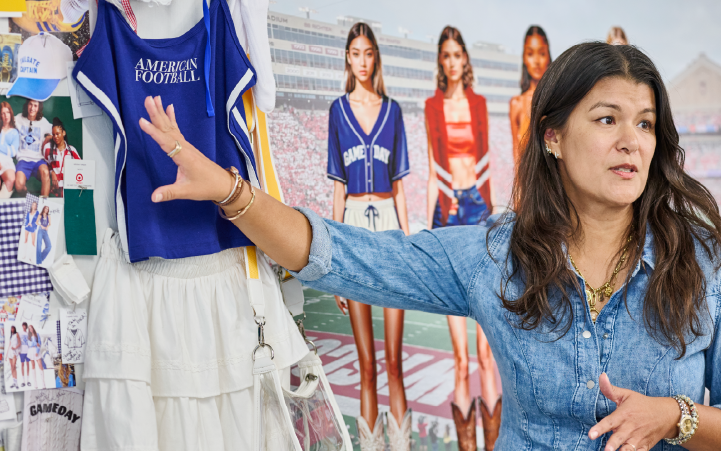A person stands in front of a wall covered in fabric pieces and color swatches, including  blue cloth with text reading "American football."