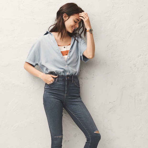 a woman leaning against a wall