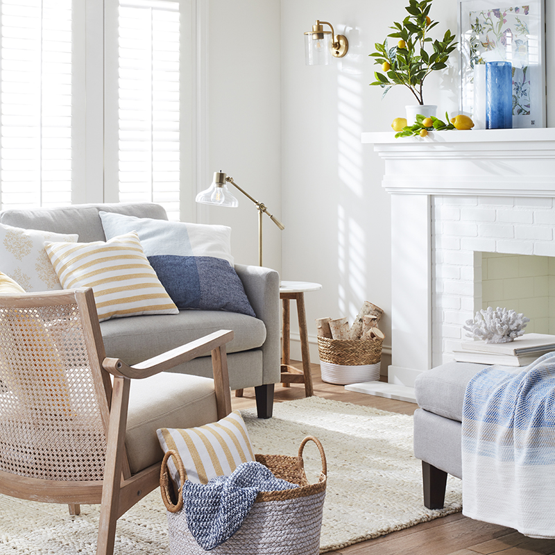 Neutral furniture is layered with soft-hued throw pillows and accents