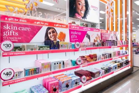Rows of colorful beauty products are flanked by value signs.