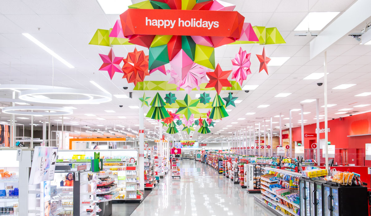 Shelves and display fixtures in a Target store filled with holiday and other gift items.