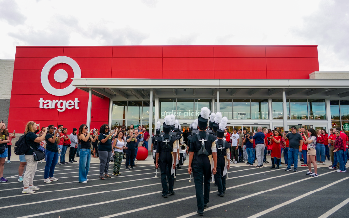 People clap outside of a Target building.