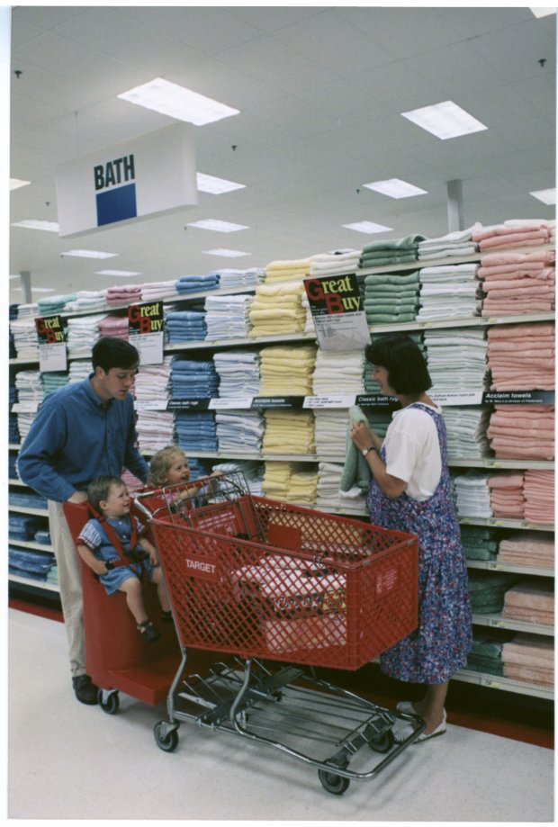 a man and woman with a baby in a shopping cart
