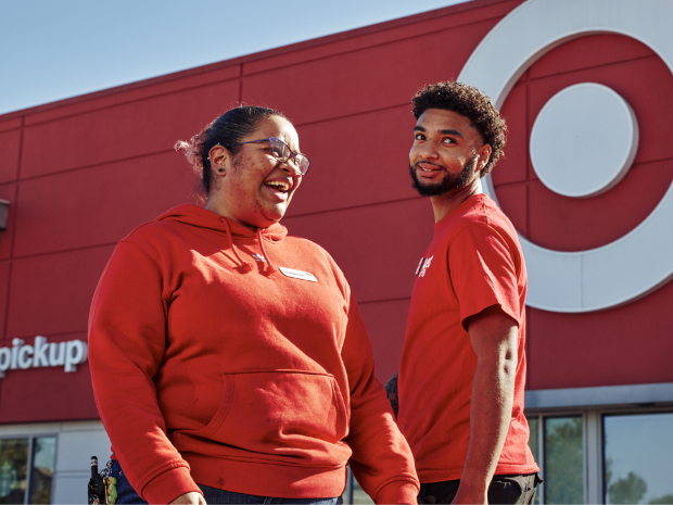Two smiling people wearing red shirts are pictured with bullseye logo
