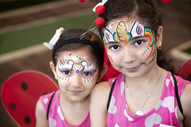 a couple of girls with face paint