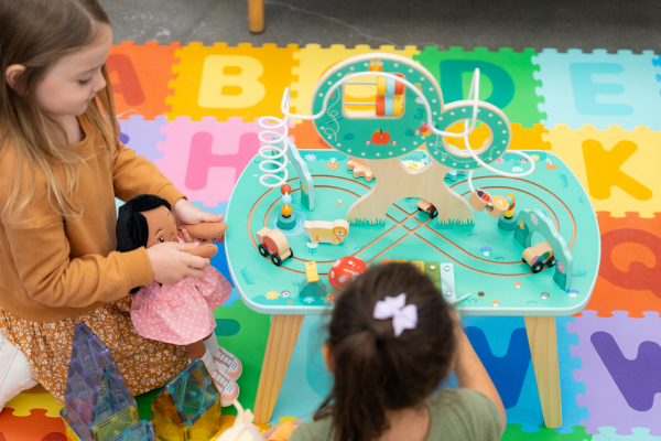 a view from above of two little girls playing with a Gigglescape toy
