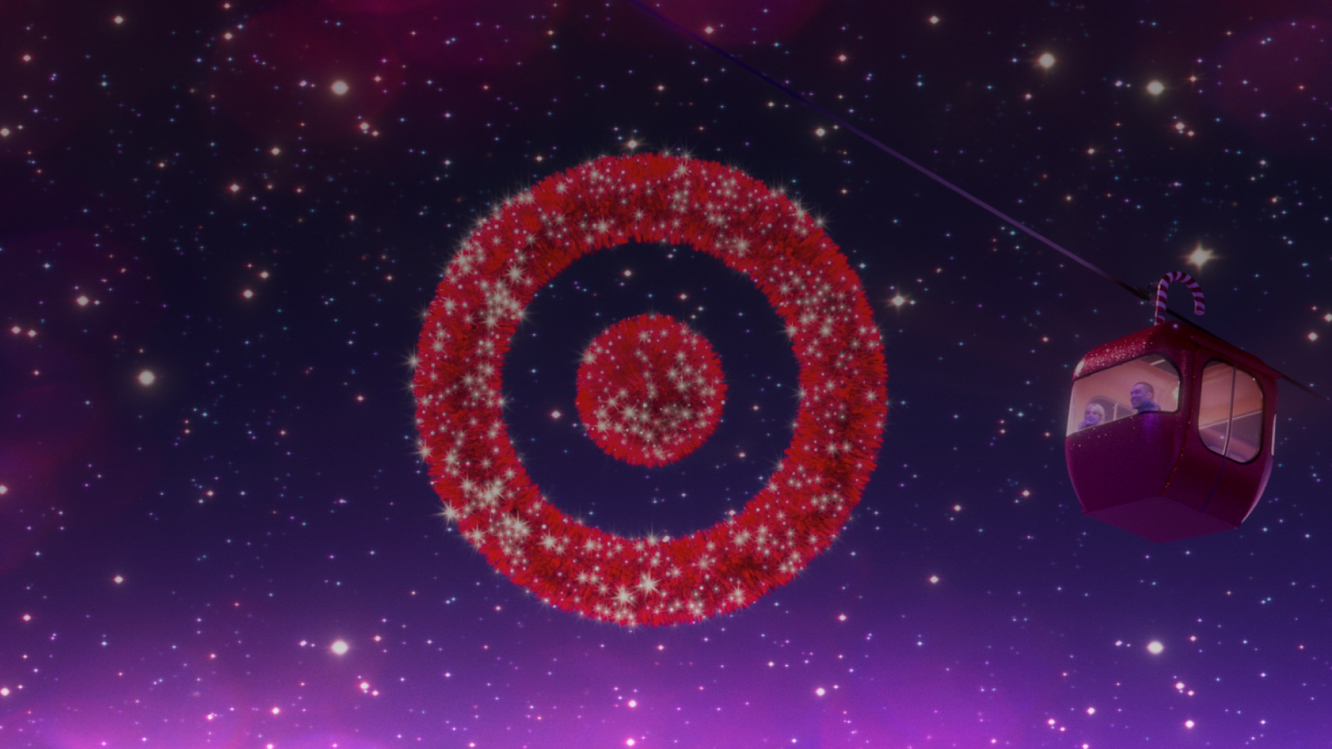 A sparkling red Target Bullseye hangs in the night sky as a red gondola goes by.